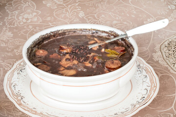 Traditional Brazilian feijoada in a rustic pan