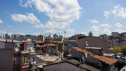 Fototapeta premium ISTANBUL, TURKEY - August 12, 2024: Panoramic view of the tall buildings of the city on a sunny summer day