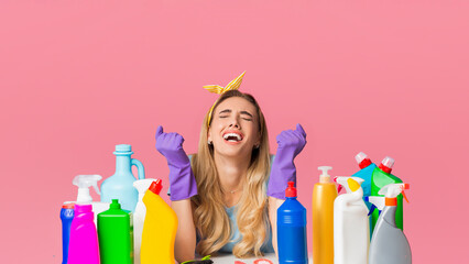 Sad housewife screams from cleaning near cleaning supplies, panorama, free space