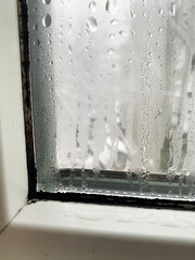 Condensation drops on the windows. Structure of wet glass in winter. Water drops on the glass surface. Texture. Problems of apartments and houses. How to solve