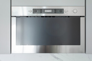 Modern stainless steel built-in microwave oven, sleek cooking technology appliance in minimalist...