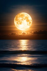 A full moon rising over the ocean at sunset