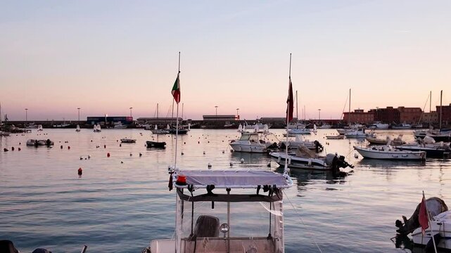 Sundown in the port of Anzio in Italy. Reflections in the water and vivid colors illuminate the scene with the boats moving. Located on the Tyrrhenian Sea dedicated to Sea dedicated to tourism
