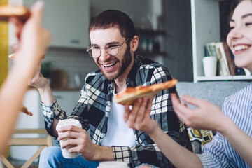 Excited friends enjoying tasty pizza together
