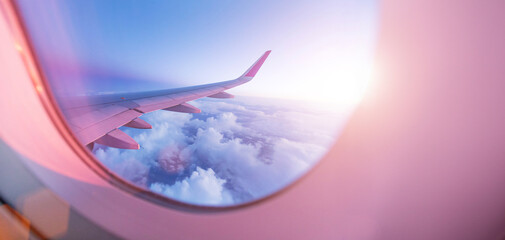 View from the cockpit of the plane to the beautiful clouds during sunset