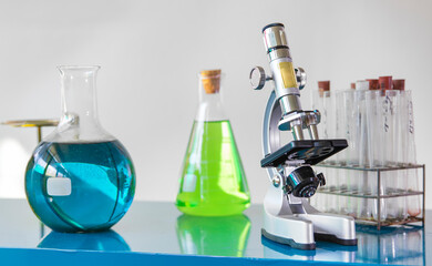 A view of a laboratory setup featuring chemical solutions in various glassware, including...