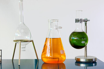 A of a laboratory setup featuring chemical solutions in glassware, including Erlenmeyer flasks and round-bottom flasks scientific research, chemistry experiments, and educational environments
