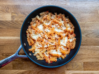 Italian recipe - fusilli pasta with mozzarella in a pan