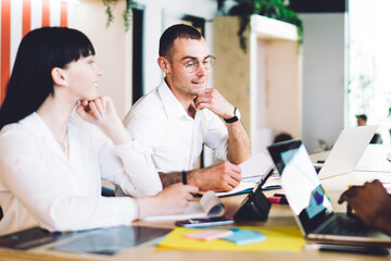 Multiracial team of creative millennials working on project