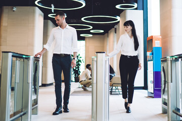 Focused coworkers going through checkpoint at workplace