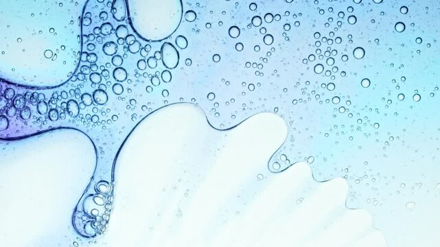 Transparent cosmetic gel fluid with molecule bubbles oil distribution on a white background. Macro Shot of Natural Organic Cosmetics, Medicine. Production Close-up. Slow Motion. High quality 4k 