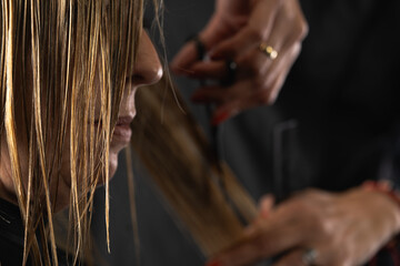 cutting client's hair with scissors