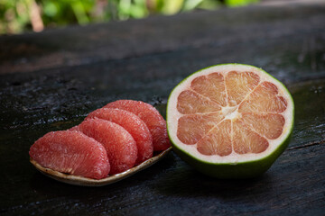  Pomelo or Citrus maxima fruit on an old wooden background.