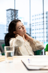 Female leader suffers from office syndrome and neck inflammation at desk, having a muscle cramp and...