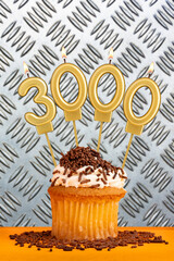 Candles in the shape of the number 3000 - Cupcake on industrial metallic background.