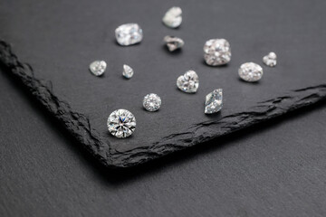 Elegant Diamond Shapes on Black Marble Floor: A stunning close-up photo showcasing the intricate design of various diamond cuts against a luxurious black marble