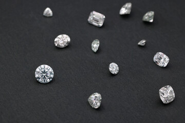Elegant Diamond Shapes on Black Marble Floor: A stunning close-up photo showcasing the intricate design of various diamond cuts against a luxurious black marble