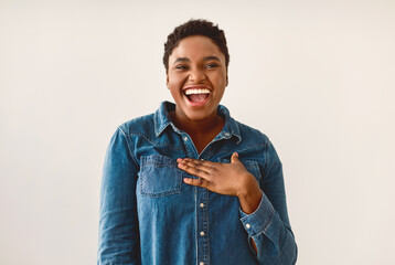 Positive Emotions Concept. Portrait of excited African American woman smiling, laughing and looking...
