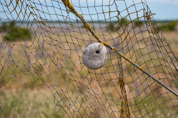 Fidhing net with a stone weight in Saaremaa, Estonia