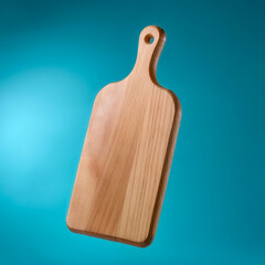 Wooden Cutting board floating or flying isolated on light blue background
