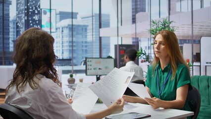 Human resources staff evaluating candidates resume in the selection process, reviewing all...