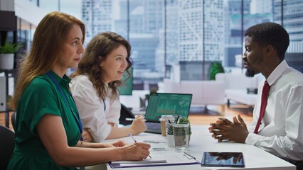 HR recruiters interviewing a job seeker and taking notes during meeting, attending an interview and conducting an evaluation. Headhunters and applicant in recruitment process. Close up. Camera B.
