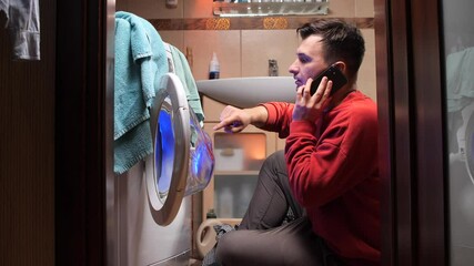 Man calling appliance repair service for washing machine breakdown