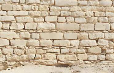 Obraz premium A close-up view of a textured stone wall with light-colored stones. AI Image