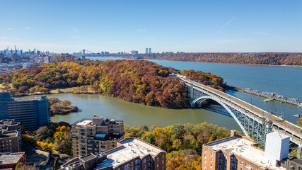 This location in the Bronx offers stunning views of lush greenery, a picturesque lake, and urban structures. Framed by the river, it showcases iconic bridges and the New York City skyline in the dista