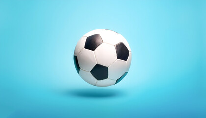 Fototapeta premium White and black soccer ball floating or flying isolated on light blue background