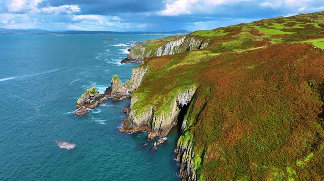 Aerial footage shows stunning cliffs by the serene ocean 4k