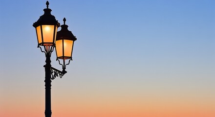 Obraz premium Elegant Street Lamp Illuminated Against a Vibrant Sunset Sky in a Serene Urban Setting