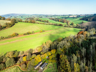 Fields and farms over Skenfrith Castle from a drone, Monmouthshire, Wales, England