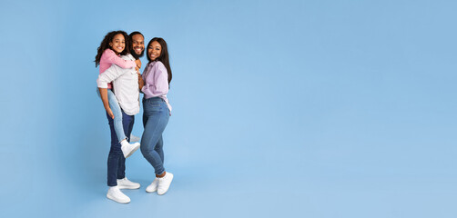 Promotion Concept. Full body length of funny black family of three people posing on blue studio...