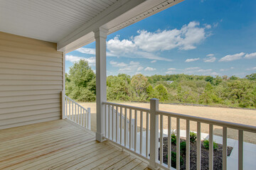 Fototapeta premium Serene Porch Area Overlooking Lush, Green Landscape