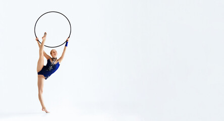 Professional athlete doing complicated gymnastic trick with hoop on white background, isolated © Prostock-studio
