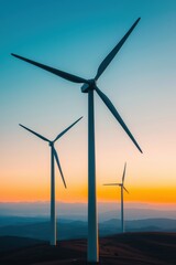 Obraz premium Wind Turbines Against a Colorful Sunset Sky