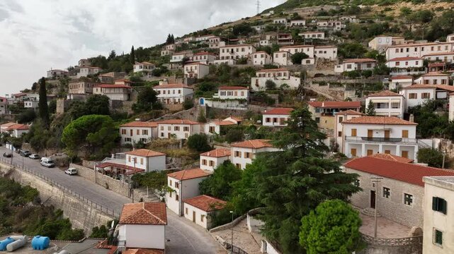 Dhermi at Sunset time. Aerial Shot of Beautiful Village Sea View, Stone Houses, beach Resort in Mountains of Albania