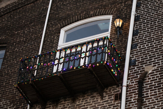 Colorful Christmas lights on apartment balcony railing