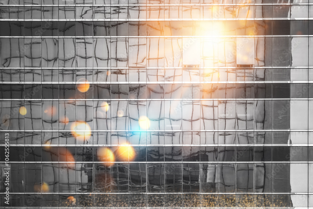 Poster a close-up of a building facade with a grid pattern and a blurred background of glowing lights.