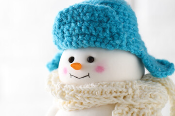 Cute decorative snowman against white background, closeup