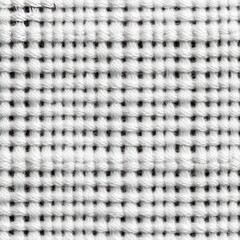 Close-up texture of white woven fabric with a grid pattern.