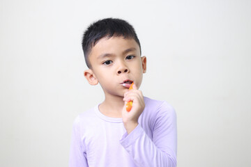 child Asia kid boy brushing teeth isolated on white backgroud.