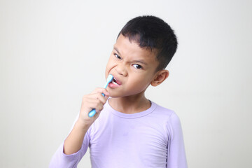 child Asia kid boy brushing teeth isolated on white backgroud.