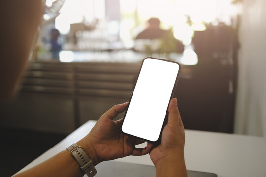 Close up of woman using cell black screen phone and sending massages on the coffee shop...