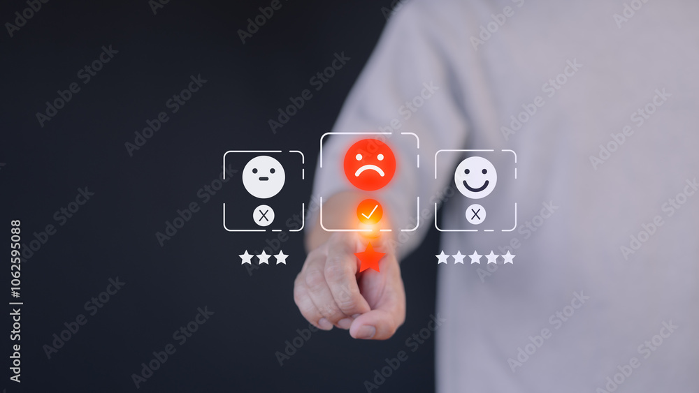 Poster A hand hovers over a digital rating interface, selecting a one-star rating with a sad face icon. This concept illustrates customer dissatisfaction, feedback, and the importance of user experience.