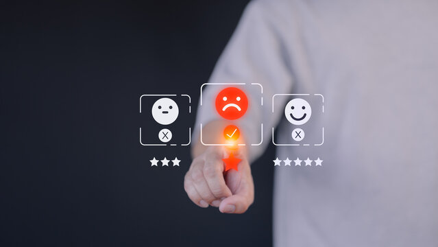 A hand hovers over a digital rating interface, selecting a one-star rating with a sad face icon. This concept illustrates customer dissatisfaction, feedback, and the importance of user experience.