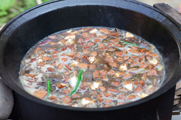 The big iron pot is making a mess of food