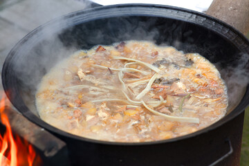 The big iron pot is making a mess of food