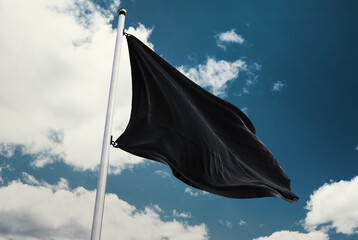 black flag on blue sky background